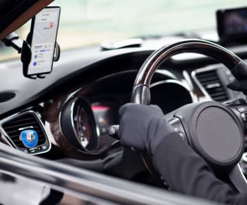 hands hold the steering wheel